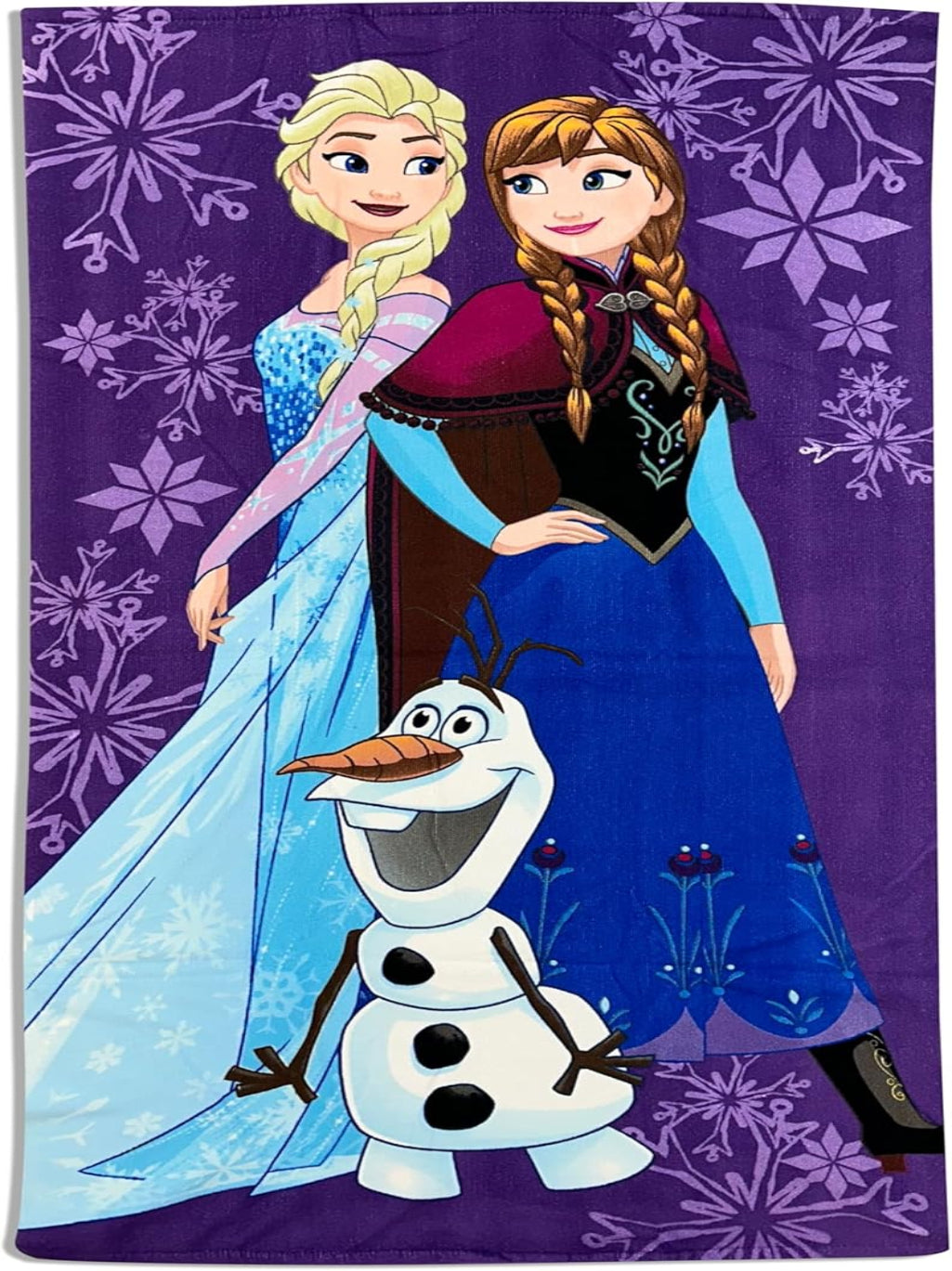 Towel featuring characters from Disney's Frozen on a purple background with snowflakes.